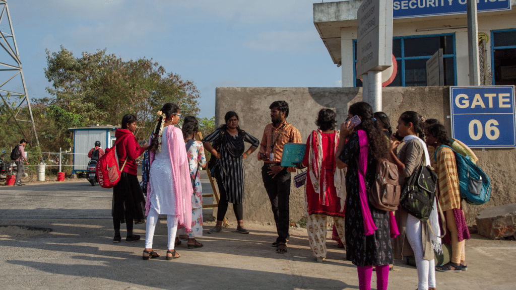 Job aspirants talk with a hiring agent outside the Foxconn factory, where workers assemble iPhones for Apple, in Sriperumbudur, near Chennai, India, April 1, 2024 | REUTERS/Palani Kumar/File Photo