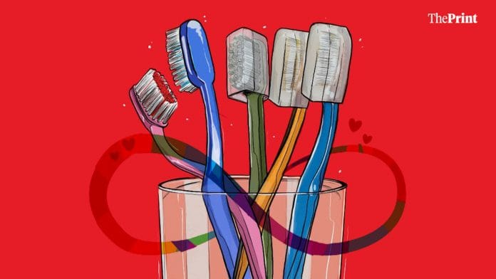 Graphic depicting polyamory through 5 toothbrushes, 2 of which are placed closer together