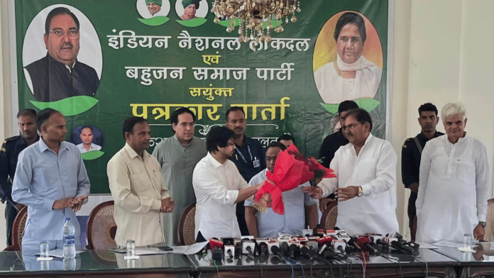 BSP's Akash Anand (left) and INLD's Abhay Singh Chautala (right) exchange pleasantries before the start of a press conference in Chandigarh | Facebook/Indian National Lok Dal - INLD