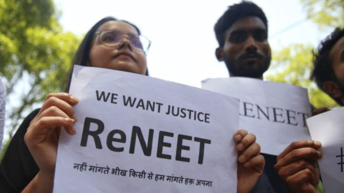 NEET applicants and doctors hold posters and answer sheets while demonstrating a protest at Delhi's Jantar Mantar demanding ReNEET exam | Photo: Manisha Mondal/ThePrint
