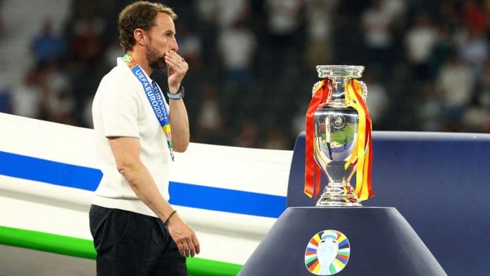 Soccer Football - Euro 2024 - Final - Spain v England - Berlin Olympiastadion, Berlin, Germany - July 14, 2024 England manager Gareth Southgate looks dejected as he walks past the trophy after receiving his runners up medal | Reuters