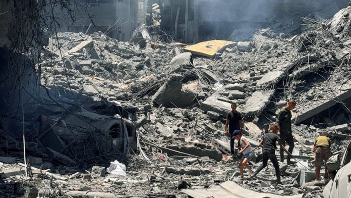 Palestinians search for casualties at the site of Israeli strikes on houses, amid Israel-Hamas conflict, in Gaza City, June 22, 2024 | Reuters