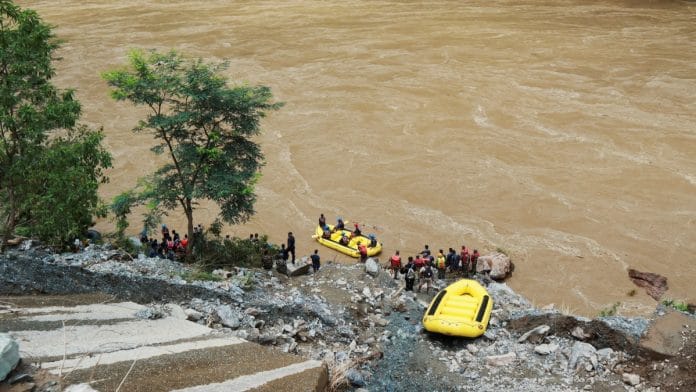 Members of rescue team search for the passenger buses that fell into the Trishuli River after the landslide at Simaltal area in Chitwan district, Nepal July 12, 2024 | Reuters