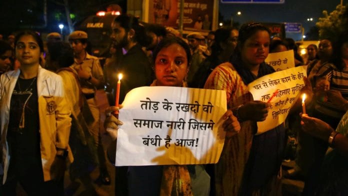 A woman holding placard during protest outside AIIMS, New Delhi, Wednesday | Manisha Mondal | ThePrint