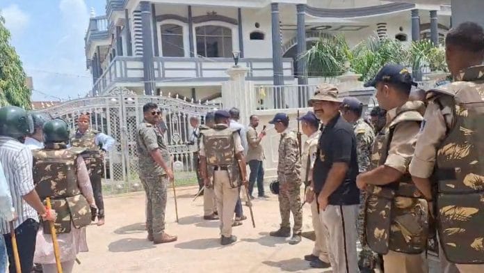 Police officers and Nagar Nigam officials outside Shehzad Ali's house, Thursday. | By special arrangement