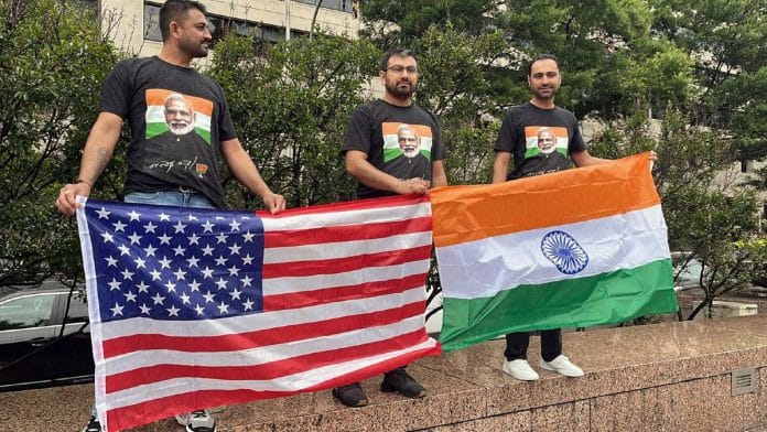 People from the Indian diaspora wear T-shirts with pictures of Prime Minister Narendra Modi and hold the flags of India and the US, to welcome the PM in Washington last June | Photo: ANI