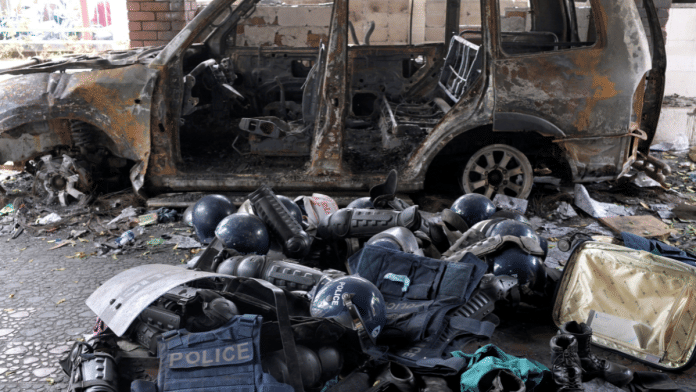Damaged riot gear of security forces is seen next to a burnt vehicle outside a police station, days after the resignation of former Bangladeshi prime minister Sheikh Hasina, in Dhaka | Reuters