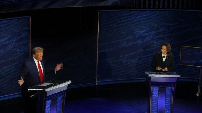 Republican presidential nominee, former U.S. President Donald Trump speaks as Democratic presidential nominee, U.S. Vice President Kamala Harris listens as they attend a presidential debate hosted by ABC in Philadelphia, Pennsylvania, U.S., September 10, 2024. REUTERS/Brian Snyder