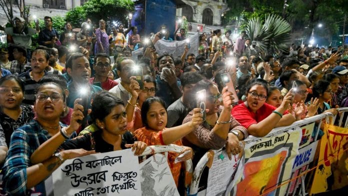People light their mobile torches at the protest site where junior doctors are sitting on a hunger strike in protest against the alleged rape and murder of a woman medic at the RG Kar Medical College and Hospital, in Kolkata on 13 October | PTI Photo