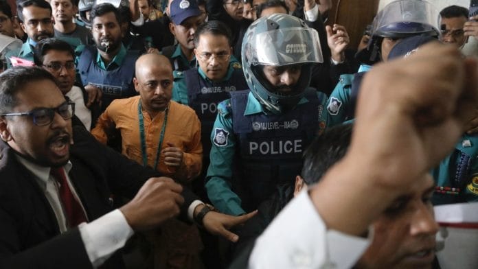 Hindu monk Chinmoy Krishna Das, escorted by police at Chattogram court on 26 Nov, 2024 | Reuters