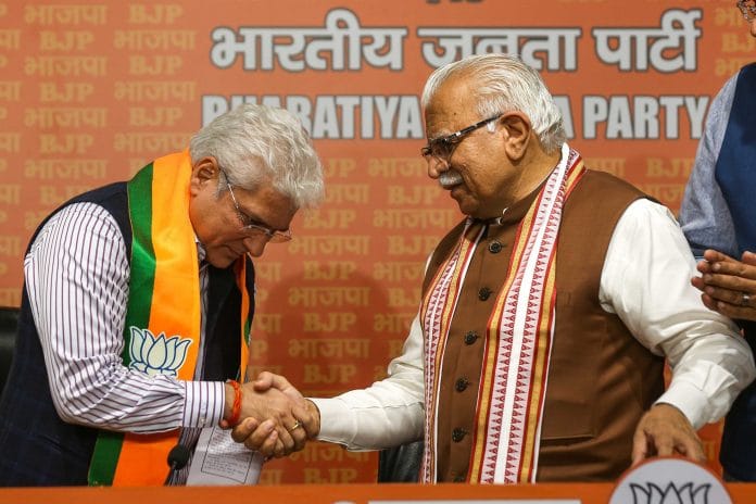 Former AAP leader Kailash Gahlot shakes hands with Union minister Manohar Lal Khattar after joining BJP in New Delhi on Monday | Suraj Singh Bisht | ThePrint