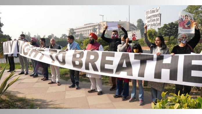 People wear masks during a protest against air pollution, near the Parliament House complex, in New Delhi, Wednesday | PTI Photo/Kamal Kishore