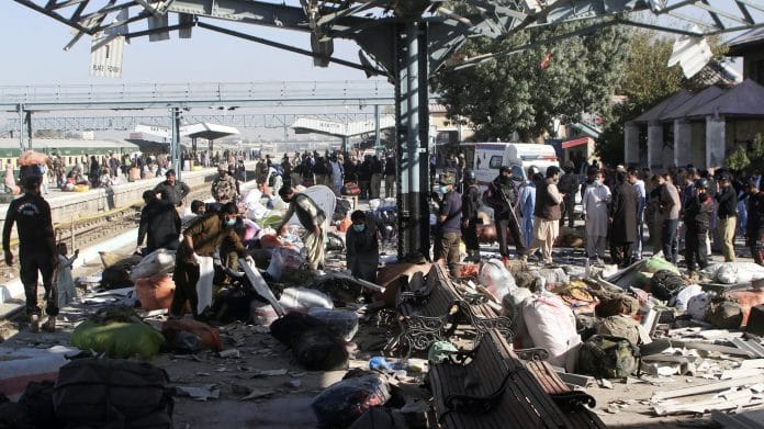 Plain-clothed police officers survey the site amid the debris after a bomb blast at a railway station in Quetta, Pakistan, 9 November 2024 | Naseer Ahmed | Reuters