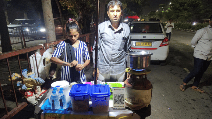 Diamond worker Rakeshbhai Dabhi with his wife at Ratnakalar stall on a street in Surat | Purva Chitnis | ThePrint