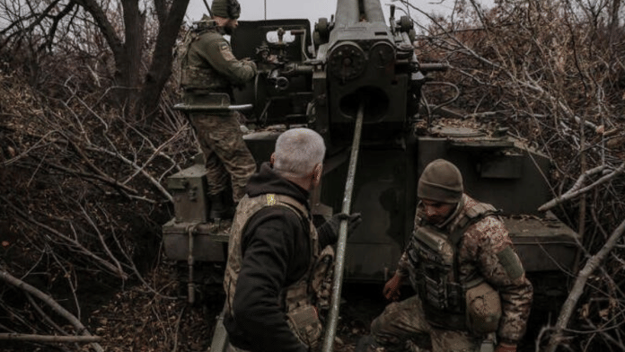 Danylo of the Ukrainian Armed Forces load a shell in a 2s5 