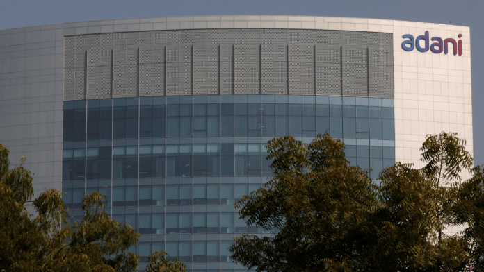 The logo of the Adani Group is seen on the facade of its Corporate House on the outskirts of Ahmedabad, India, 22 November 2024. | Amit Dave | Reuters