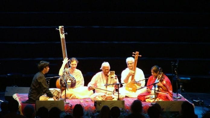 Sarangi player Ram Narayan (middle) and his daughter Aruna Narayan (right, in red) play in the Royal Albert Hall for Indian Voices Day for BBC's The Proms, 2009 | Photo: Wikimedia Commons