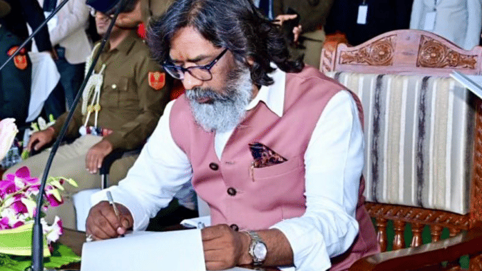 JMM executive president Hemant Soren signs after taking oath as the 14th Chief Minister of Jharkhand, in Ranchi | ANI
