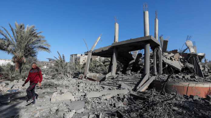 A Palestinian man walks at the site of an Israeli strike on a house, amid the Israel-Hamas conflict, in Deir Al-Balah in the central Gaza Strip on 4 December, 2024 | Reuters/ Ramadan Abed