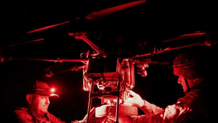 Ukrainian servicemen of drone squadron Rarog of 24 separate mechanised brigade attach an anti-tank mine to a Vampire combat drone before flying over positions of Russian troops, amid Russia's attack on Ukraine, in the frontline town of Chasiv Yar, Donetsk region, Ukraine on 26 June 2024. | Inna Varenytsia | Reuters