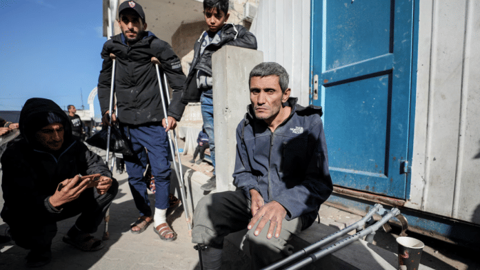 A Palestinian, evacuated from Kamal Adwan hospital in northern Gaza after Israeli forces raided the medical facility, sits next to crutches, amid the ongoing conflict between Israel and Hamas, in Gaza City, on 28 December 2024. | Dawoud Abu Alkas | Reuters