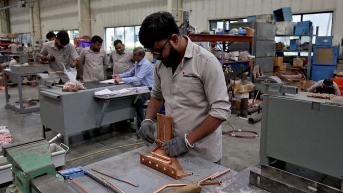 Employees assemble an electric transformer inside a manufacturing unit of Inductotherm (India) Private Limited at Sanand GIDC (Gujarat Industrial Development Corporation), on the outskirts of Ahmedabad, India, on 28 March 2024. | Amit Dave | Reuters