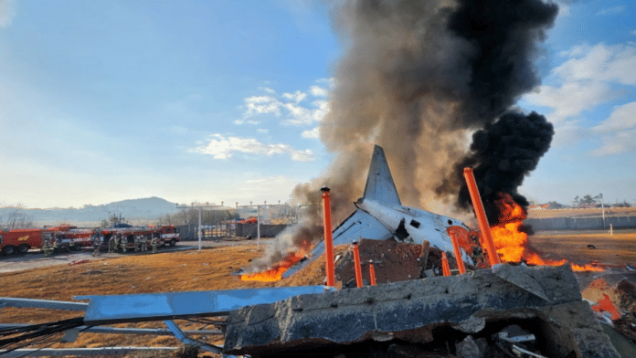 Firefighters carry out extinguishing operations on an aircraft which drove off runaway at Muan International Airport in Muan, South Jeolla Province, South Korea, on 29 December 2024. | Yonhap via Reuters