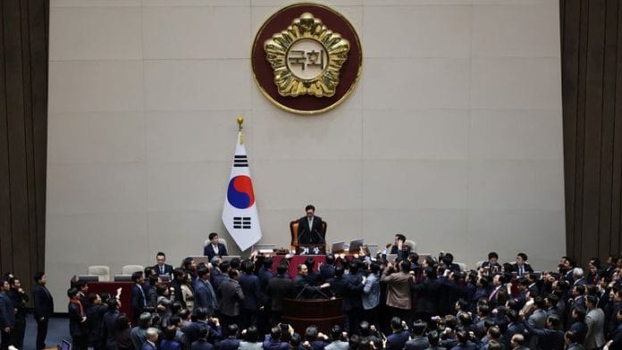 South Korea’s ruling People Power Party lawmakers protest against National Assembly Speaker Woo Won-shik during the impeachment vote of a plenary session for South Korean acting President and Prime Minister Han Duck-soo at the National Assembly in Seoul, South Korea, 27 December 2024 | Reuters