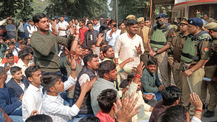 Police try to pacify students who were reciting Hanuman Chalisa on the campus of UP College following a notice by the Waqf Board, in Varanasi, on 3 December 2024. | PTI