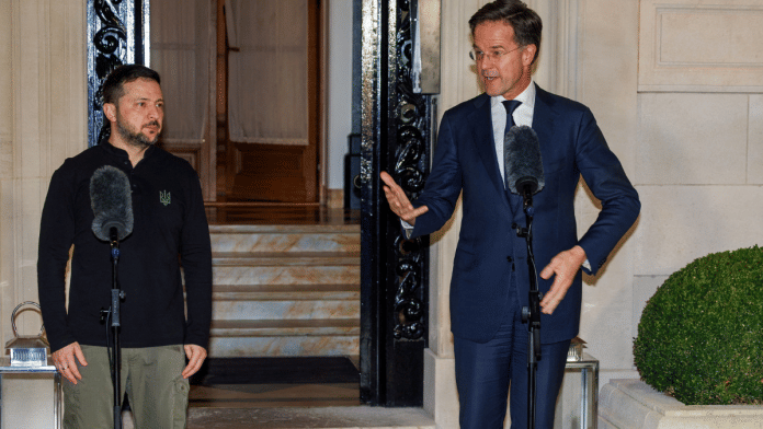 NATO Secretary General Mark Rutte stands next to President of Ukraine Volodymyr Zelenskiy at the NATO Secretary General Residence, in Brussels, Belgium, on 18 December 2024. | Olivier Matthys | Pool via Reuters
