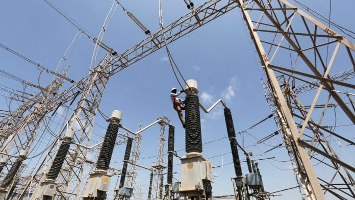 A technician repairs power supply lines at a power plant of Adani Power at Mundra Port in the western Indian state of Gujarat April 2, 2014 | Reuters file photo