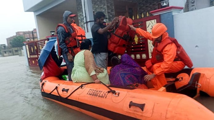 National Disaster Response Force (NDRF) personnel rescue stranded residents following heavy rainfall triggered by Cyclone Fengal, in Cuddalore, Sunday.