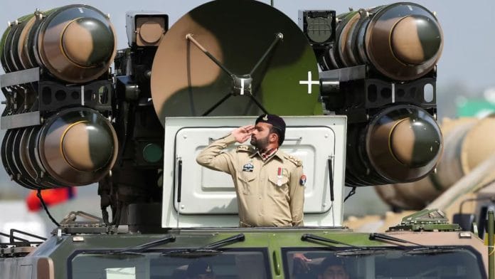 Pakistani Army soldier salutes while standing on an air defence missile system during Pakistan Day military parade in Islamabad, Pakistan, March 23, 2022. REUTERS/Saiyna Bashir/File Photo