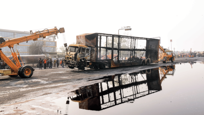 Cranes carry the charred remains of a truck at the site of the accident after a massive fire started due to a collision between a gas tanker and multiple vehicles near a petrol pump on the Jaipur-Ajmer Highway, in Jaipur on Friday. Reportedly, Four people died and several injured in the accident | ANI