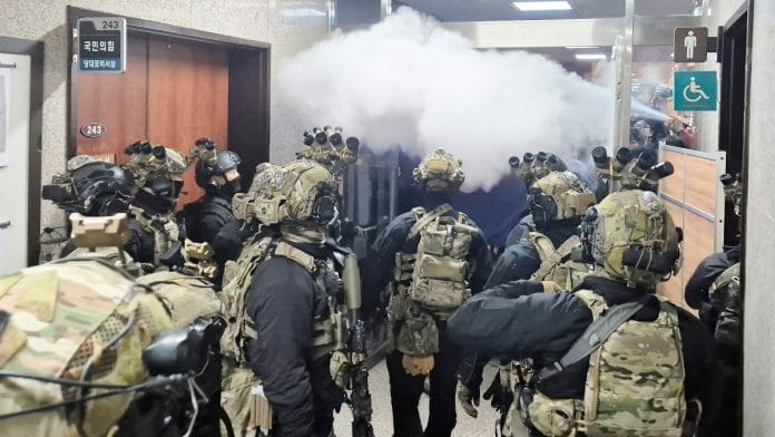 Soldiers advance to the main building of the National Assembly after South Korean President Yoon Suk Yeol declared martial law in Seoul, South Korea, December 3, 2024 | Yonhap via Reuters