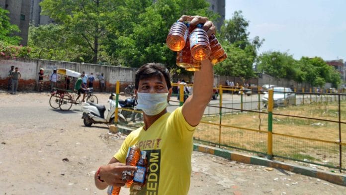 A man carrying alcohol bottles in Anand Vihar | Photo: ANI