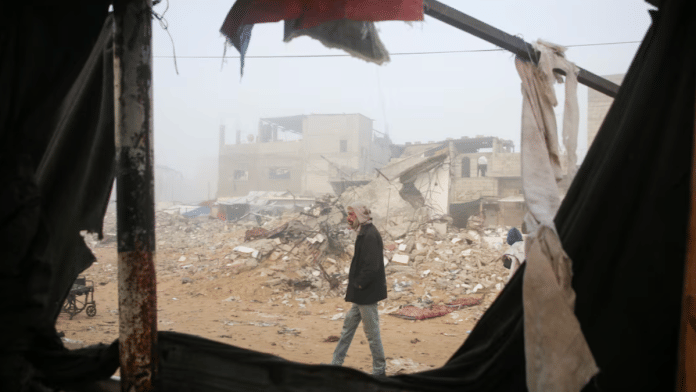 A Palestinian man inspects the damage to a tent for displaced people, after an Israeli airstrike, amid the conflict between Israel and Hamas, in Khan Younis, southern Gaza Strip, on 17 January 2025. | Hatem Khaled | Reuters