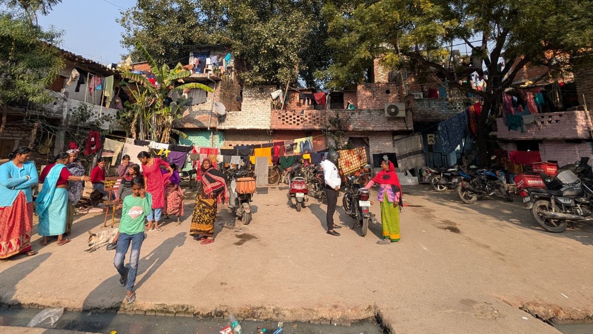 Women and children gather in an open area inside Karpuri Thakur Jan Jivan Camp. | Apoorva Mandhani | ThePrint