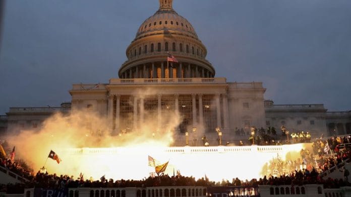 An explosion caused by a police munition is seen while supporters of President Donald Trump riot in front of the U.S. Capitol Building in Washington on 6 January 2021 | Reuters/Leah Millis