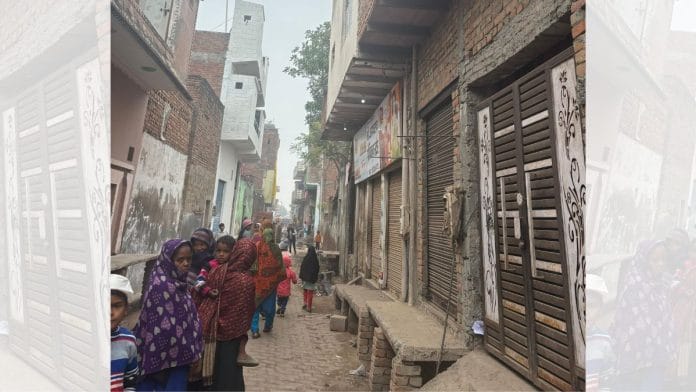 Neighbours gather around Arshad's house (right) in Islamnagar | Bismee Taskin | ThePrint