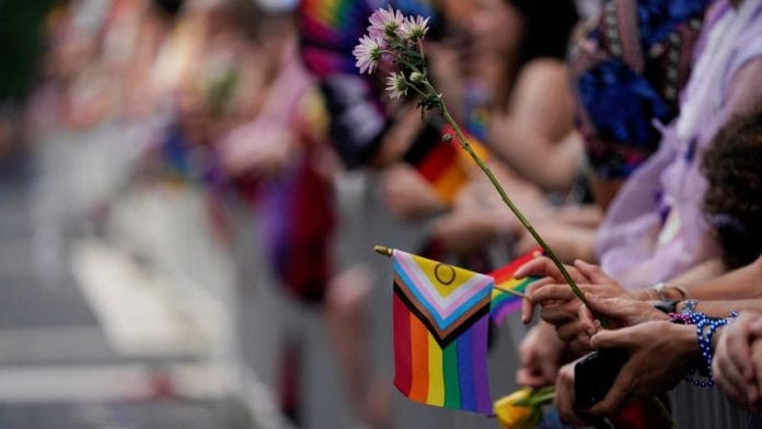 Representational Image | People hold flowers and flags during the annual LGBTQ+ Capital Pride parade in Washington, US | Reuters/Nathan Howard