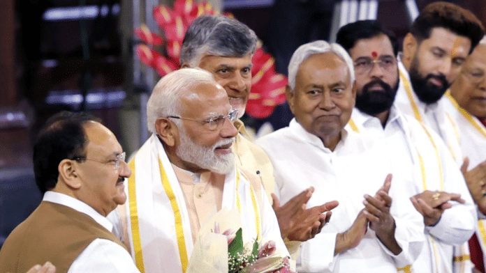 File photo of PM Narendra Modi being felicitated at a NDA parliamentary party meeting. CMs N Chandrababu Naidu and Nitish Kumar (third & fourth from left) are also present on the dais | ANI