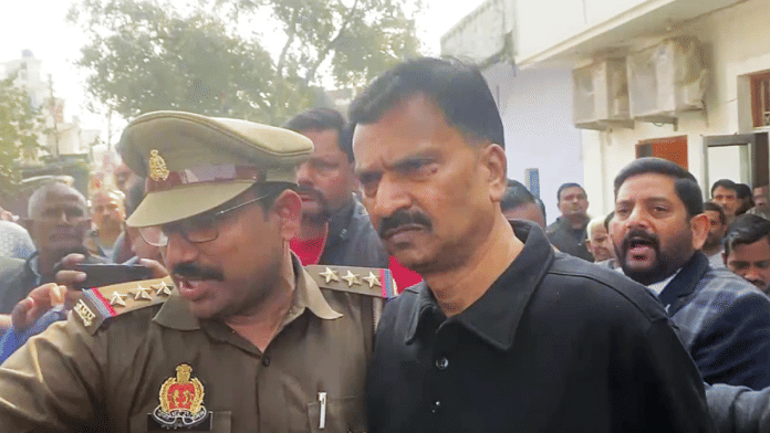 Congress MP Rakesh Rathore is escorted by UP Police after his arrest in a rape case | ANI