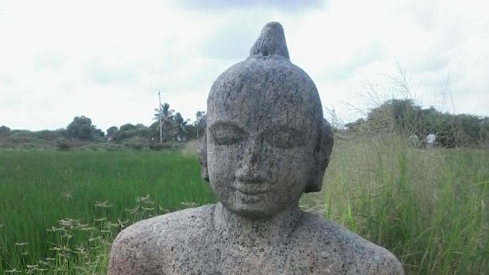 A stone idol of Buddha found in a paddy field in Rameswaram, 2015