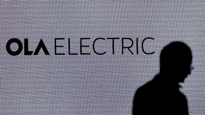 A man walks past the logo of Ola Electric during a press conference ahead of it's IPO launch in Mumbai, India, July 29, 2024 | Reuters file photo