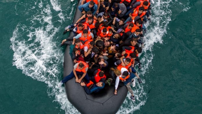 In this drone view an inflatable dinghy carrying migrants makes its way towards England in the English Channel, Britain, August 6, 2024 | Reuters file photos