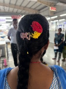 Ashwini Naik, an Odia woman employed at the Coimbatore mill, flaunting the flowers in her oiled braid | Photo: Sagrika Kissu, ThePrint