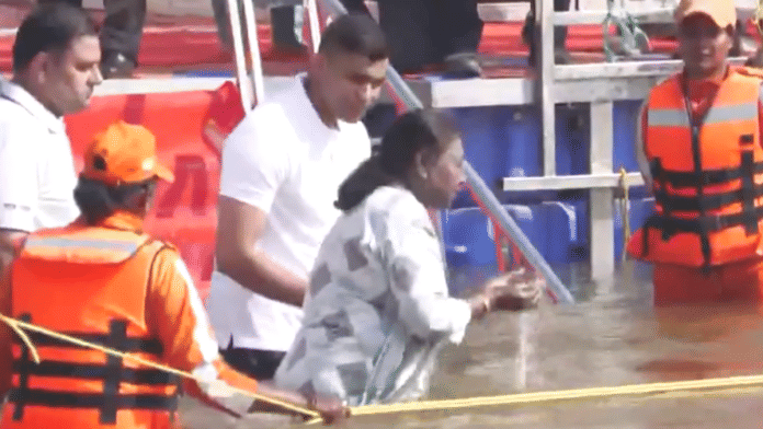 President Droupadi Murmu takes a holy dip at Triveni Sangam during the ongoing Maha Kumbh Mela. | Screen grab | ANI