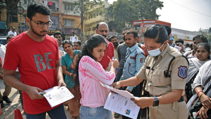 File photo of a cop checking identity cards of JEE candidates in Hyderabad | ANI