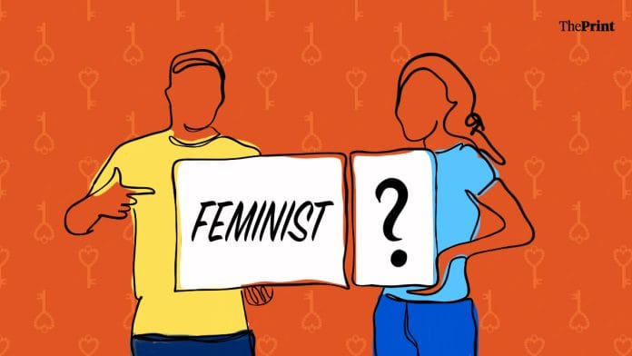 A man holds up a placard that reads 'feminist' while a woman holds up one with a giant question mark.